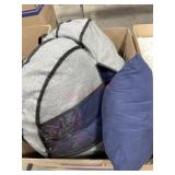 Grey tote bag full of navy blue throw pillows