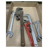 Flat with pipe wrenches and end wrenches