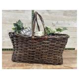 Brown basket with greenery, doilie and misc.