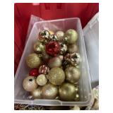 Red tote of Christmas ornaments and decore