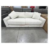 Modern cream colored cloud sofa needs cleaned