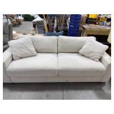 Beige Upholstered Sofa With Damaged Leg