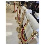 GOLD STANCHIONS WITH RED VELVET CORDS