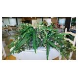 Woven split wood oval basket full of faux ferns,