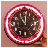 2 wall cocks, one is pink neon