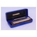 M. Hohner Blues Harp harmonica and 2 cases