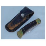 Buck 110 single blade hunting knife in leather
