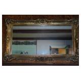 Large beveled wall mirror in gilded ornate frame,