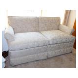 Custom upholstered loveseat on casters, 63" wide