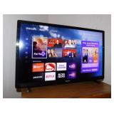 Philips 24" Roku TV television w/ remote on stand