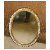 Oval wall mirror in gilded ornate frame,