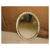 Oval wall mirror in gilded ornate frame, 18" x