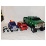 4 plastic toy trucks