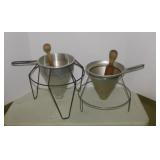 2 vintage aluminum cone sieves in stand w/ wooden