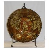 Large gilded glass tray on wrought iron tabletop