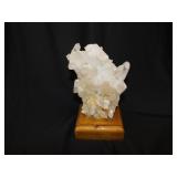 Milky quartz crystal cluster on wood display
