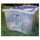 Flip-top storage tote full of vintage girl clothes