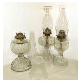 3 antique glass oil lamps - 4 glass chimneys &