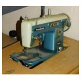 Modern 100 Deluxe sewing machine in cabinet -