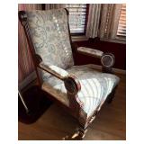 Vintage Armchair Featuring a High Back, Light