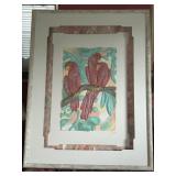 A shadow box type frame of a trio of parrots