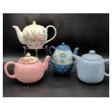 Four Ceramic Teapots with Various Designs