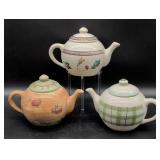 Three Ceramic Teapots with Painted Designs