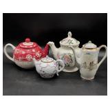 Four Ceramic Teapots with Various Designs