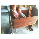 wooden crib and dolls