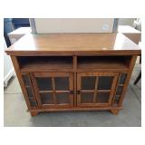 Wood T.V. Stand With 2 Glass Doors In Good