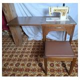 Singer sewing machine in table with seat