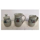 Trio of signed pottery pieces. Mug, creamer, and