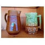 Pottery pitcher featuring leaf and acorn design &