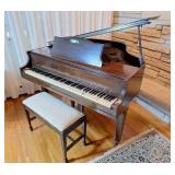 Wurlitzer Grand Piano with piano music/books.