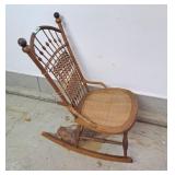 Wooden rocking chair with basket weave back and