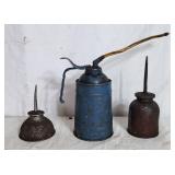 3 old oil cans
