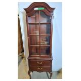 Vintage curio cabinet features a dark brown