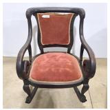 Vintage dark wood rocking chair, has distinctive
