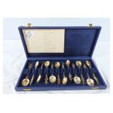 12 collector spoons im case. Markings unclear.