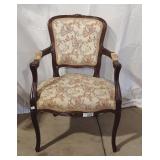Vintage armchair features a hand-carved Rococo