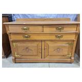 Antique oak buffet featuring ornate brass