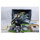 Bin full of cords and adapters in packages and