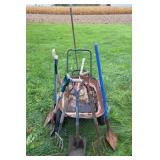 Wheel barrow with garden tools: shovels, axe,
