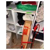 White Shelf Unit With Contents in Center of Pictur