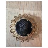 Gold-Tone Filigree Brooch with Black Cameo Portrai