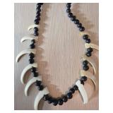 Necklace With Black Beads and Animal Tooth Pendant
