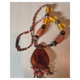 Beaded Necklace with Amber-Colored Pendant Featuri