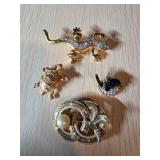 Four Gold-Tone Animal and Ornamental Brooches