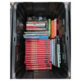 Hardcover and Paperback Books Inside a Storage Bin