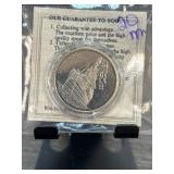 Silver Coin Featuring Ship Design in Protective Pa
